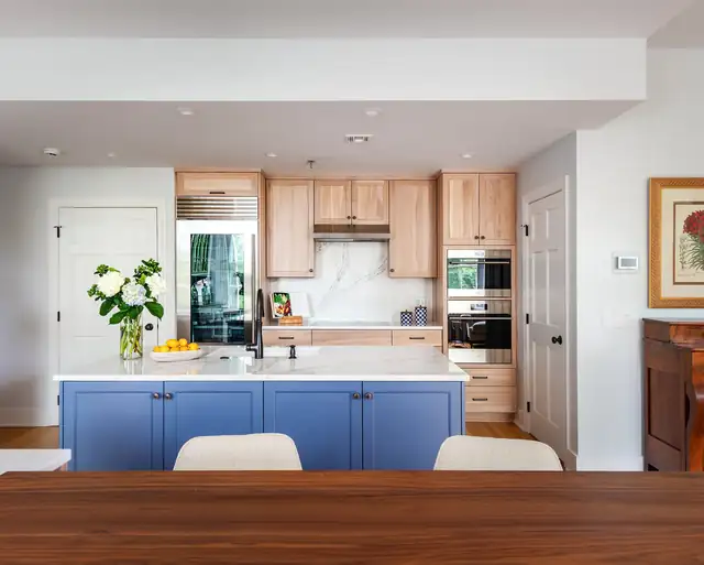 Fresh and Bright Pied-a-Terre kitchen in Richmond with a periwinkle blue island, light wood cabinets and a marble-look backsplash